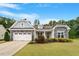 Charming single Gathering home featuring stone accents and a well-manicured lawn at 704 Long Lake Dr, Fuquay Varina, NC 27526