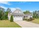 Charming two-story home with a stone and gray facade, well-manicured lawn, and two-car garage at 704 Long Lake Dr, Fuquay Varina, NC 27526