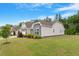 Charming two-story home with a stone and gray facade, well-manicured lawn, and inviting curb appeal at 704 Long Lake Dr, Fuquay Varina, NC 27526