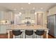 Spacious kitchen featuring a large center island with granite countertops and seating at 704 Long Lake Dr, Fuquay Varina, NC 27526