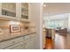 Bright kitchen featuring granite countertops, subway tile backsplash, and white cabinetry at 704 Long Lake Dr, Fuquay Varina, NC 27526