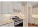 Close-up of kitchen with stainless steel range and granite countertops at 704 Long Lake Dr, Fuquay Varina, NC 27526