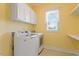 Laundry Room featuring side-by-side washer and dryer, and storage cabinets at 704 Long Lake Dr, Fuquay Varina, NC 27526