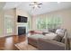 Cozy living room with fireplace, large windows, and hardwood floors at 704 Long Lake Dr, Fuquay Varina, NC 27526