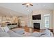 Open concept living room featuring kitchen with large island, vaulted ceilings, and fireplace at 704 Long Lake Dr, Fuquay Varina, NC 27526