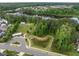 Aerial view of a park featuring walking paths, a pond, shelters, and green spaces in a residential area at 704 Long Lake Dr, Fuquay Varina, NC 27526