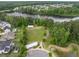 Aerial view of a park featuring walking paths, a pond, shelters, and green spaces near residences at 704 Long Lake Dr, Fuquay Varina, NC 27526