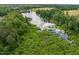 Scenic aerial view of a large pond surrounded by verdant trees and lush landscapes at 704 Long Lake Dr, Fuquay Varina, NC 27526