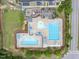 Aerial view of community pool featuring lap lanes, a pool, playground, and ample seating at 704 Long Lake Dr, Fuquay Varina, NC 27526