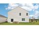 Exterior side view of a white home featuring a patio, green lawn, and siding at 705 Holstein Dairy Way, Wake Forest, NC 27587