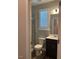 Modern bathroom with a glass-enclosed shower, updated fixtures, and natural light from the window at 712 Emmer St, Rolesville, NC 27571