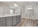 Elegant bathroom with a double vanity, granite countertops, large mirror, and glass-enclosed shower at 712 Emmer St, Rolesville, NC 27571