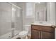 Cozy bathroom featuring a glass-enclosed shower, toilet, wood vanity, and wood-look flooring at 712 Emmer St, Rolesville, NC 27571