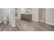 Bathroom with a gray double vanity, wood-look tile flooring, and a separate toilet area at 712 Emmer St, Rolesville, NC 27571