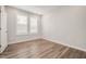 Bright bedroom with plank floors, white walls, and ample natural light from the large window at 712 Emmer St, Rolesville, NC 27571