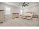 Spacious bedroom with a large bed, dark ceiling fan, and windows with ample natural light at 712 Emmer St, Rolesville, NC 27571