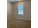 Minimalist bedroom with large window providing plenty of natural light at 712 Emmer St, Rolesville, NC 27571