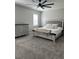 Bright bedroom with neutral colored furniture, ceiling fan, and plush bed at 712 Emmer St, Rolesville, NC 27571
