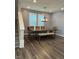 Elegant dining room featuring a modern light fixture, hardwood floors, and a large dining table at 712 Emmer St, Rolesville, NC 27571
