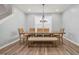 Dining area featuring a wooden table with bench seating, pendant lighting, and wood-look flooring at 712 Emmer St, Rolesville, NC 27571