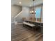 Elegant dining room area with hardwood floors, modern lighting, and staircase nearby at 712 Emmer St, Rolesville, NC 27571