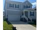 Charming two-story home with light gray siding, a two-car garage, and manicured front lawn at 712 Emmer St, Rolesville, NC 27571
