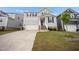 Two-story home with a gray exterior, a brick-lined staircase, and an attached two-car garage at 712 Emmer St, Rolesville, NC 27571