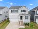 Charming two-story home featuring a gray exterior, black shutters, and a well-manicured front yard at 712 Emmer St, Rolesville, NC 27571