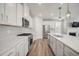 Modern kitchen featuring white cabinets, stainless steel appliances, subway tile backsplash, and a large island at 712 Emmer St, Rolesville, NC 27571