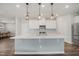 Kitchen island with pendant lighting and white shaker cabinets at 712 Emmer St, Rolesville, NC 27571