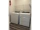 Bright laundry room with modern washer and dryer units and overhead shelving at 712 Emmer St, Rolesville, NC 27571