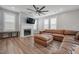 Bright living room features fireplace, ceiling fan, a large leather sectional and lots of natural light at 712 Emmer St, Rolesville, NC 27571