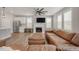 Bright living room features fireplace, ceiling fan, a large leather sectional and lots of natural light at 712 Emmer St, Rolesville, NC 27571