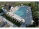 Aerial view of community pool with ample lounge chairs and a nearby clubhouse, ideal for recreation at 712 Emmer St, Rolesville, NC 27571