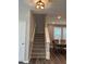 Staircase view nearby a modern dining area with hardwood floors and natural light at 712 Emmer St, Rolesville, NC 27571