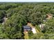 An aerial view of a charming home surrounded by lush trees and greenery at 7204 Laketree Dr, Raleigh, NC 27615
