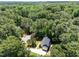 Aerial view of a cozy home nestled in a vibrant, green, wooded neighborhood at 7204 Laketree Dr, Raleigh, NC 27615