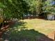 Spacious back yard with a firepit area and storage shed at 7204 Laketree Dr, Raleigh, NC 27615
