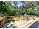 Wooden deck with seating that overlooks spacious, grassy back yard at 7204 Laketree Dr, Raleigh, NC 27615