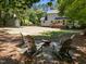 Back yard with firepit area, chairs, and deck attached to home at 7204 Laketree Dr, Raleigh, NC 27615