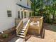 Wooden deck with stairs that lead to a large back yard with pine straw at 7204 Laketree Dr, Raleigh, NC 27615