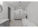 Bright bathroom featuring double shower heads, a soaking tub, and modern fixtures at 7204 Laketree Dr, Raleigh, NC 27615