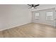 Spacious bedroom with hardwood floors, a ceiling fan, and bright natural light at 7204 Laketree Dr, Raleigh, NC 27615