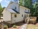 Two-story home with a large backyard, deck, and stepping stone walkway at 7204 Laketree Dr, Raleigh, NC 27615