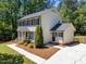 Charming two-story traditional home featuring a well-manicured lawn, black shutters and a driveway at 7204 Laketree Dr, Raleigh, NC 27615