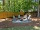 Back yard featuring a gravel firepit area with Adirondack chairs at 7204 Laketree Dr, Raleigh, NC 27615