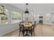 Eat in Kitchen featuring white cabinets, modern fixtures and a view of the backyard at 7204 Laketree Dr, Raleigh, NC 27615
