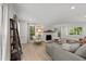 Bright living room features a fireplace, neutral decor and wood floors at 7204 Laketree Dr, Raleigh, NC 27615