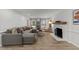 Open concept living room with neutral colors, a fireplace and comfortable seating at 7204 Laketree Dr, Raleigh, NC 27615