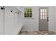 Bright mudroom with built-in shelving, coat hooks, a bench, and a view of the outdoors at 7204 Laketree Dr, Raleigh, NC 27615